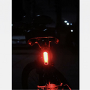 nzmegabuy USB rechargeable LED bicycle tail light glowing red on a bike seat post at night for high visibility