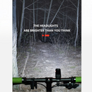 nzmegabuy USB rechargeable LED bike headlight illuminating a dark forest trail at night from a cyclist perspective