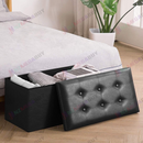 nzmegabuy black faux leather foldable storage ottoman bench with button-tufted lid placed at the foot of a bed