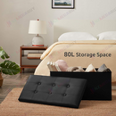 nzmegabuy black faux leather foldable storage ottoman bench with button-tufted lid placed at the foot of a bed