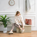 nzmegabuy beige foldable storage ottoman bench used as a seat by a woman in a bright living room setting
