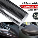 nzmegabuy 5D gloss black carbon fibre vinyl wrap applied to a car dashboard and side mirror for a sleek finish