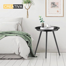 nzmegabuy black round metal bedside table with three legs in a modern bedroom setting with a plant and book
