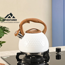 nzmegabuy 3L white stainless steel whistling tea kettle with a textured finish and wood-look handle on a stovetop
