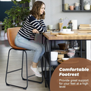 nzmegabuy Ichairium whisky brown PU leather bar stool with black steel frame, used by a woman at a kitchen island