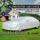 nzmegabuy 3-layer waterproof aluminum car cover with reflective strips, protecting a sedan on a grassy lawn