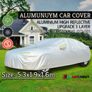 nzmegabuy 3-layer waterproof aluminum car cover with reflective strips, protecting a sedan on a grassy lawn.