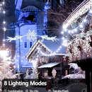 nzmegabuy 12m solar fairy lights with 100 cold white LEDs illuminating a snowy outdoor festive scene