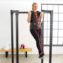 nzmegabuy woman performing a pull-up with a red heavy-duty latex resistance band on a gym power rack