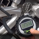 nzmegabuy digital tire inflator with pressure gauge displaying a reading while connected to a car wheel