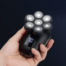 nzmegabuy 7D electric head shaver with seven floating rotary blades and a digital battery display held in a hand