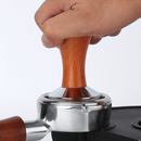 nzmegabuy stainless steel espresso tamper with wooden handle being used to press coffee grounds in a portafilter