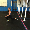 Woman performing a lunge with a nzmegabuy heavy-duty latex resistance band anchored to a gym rig for strength training.