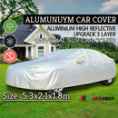 nzmegabuy 3-layer waterproof aluminum car cover with reflective strips, protecting a vehicle on a grassy lawn.