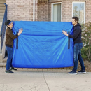 Two men carrying a blue RYANNA heavy duty tarp mattress storage bag with reinforced handles for moving