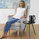 nzmegabuy black round metal side table next to a woman sitting in a grey armchair in a modern living room