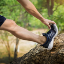 nzmegabuy nude plantar fasciitis compression sock worn under a dark sneaker while stretching outdoors on a tree trunk