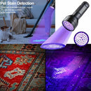 nzmegabuy 51 LED UV flashlight emitting purple light to detect pet urine stains on a carpet in a living room