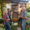 nzmegabuy 8-layer mesh herb drying rack hanging in a garden with four people inspecting the dried plants inside.