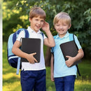 Two young boys holding black PU leather 900-capacity card collector albums from nzmegabuy in an outdoor park setting.