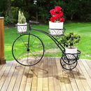 nzmegabuy black metal tricycle plant stand with three basket tiers displayed on a wooden deck in a garden