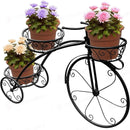 nzmegabuy black metal tricycle plant stand with three basket tiers holding potted flowers in a Parisian style