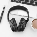 nzmegabuy black replacement ear pads installed on Bose QC35 headphones resting on a desk with a laptop and coffee