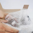 nzmegabuy clear bubble wrap roll cushioning a glass item inside a cardboard box for safe shipping and storage