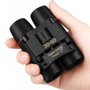 nzmegabuy compact 30x60 binoculars in black with red membrane coated optics held in a hand for travel and hunting