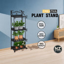 nzmegabuy CREAVITA 4-tier black steel plant stand with decorative scrollwork, holding potted plants in a living room.