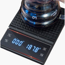 nzmegabuy digital drip coffee scale with built-in timer and LCD display showing weight and time under a glass carafe