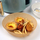 nzmegabuy disposable round parchment paper air fryer liner holding egg tarts, chicken, and fries near an air fryer