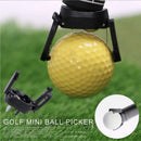 nzmegabuy black plastic golf ball retriever tool attached to a putter grip, picking up a yellow golf ball on grass
