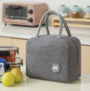 nzmegabuy grey insulated lunch bag with carry handles and bear logo patch on a kitchen counter