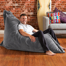 nzmegabuy LAZY BEAN grey velvet floor cushion cover being used by a man in a relaxed lounge setting