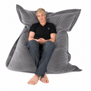 nzmegabuy LAZY BEAN grey velvet floor cushion with a young man sitting comfortably on it against a white background