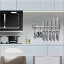 nzmegabuy silver magnetic knife strip mounted on a kitchen wall holding various knives, scissors, and utensils.
