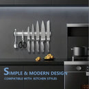 nzmegabuy silver magnetic knife strip mounted on a dark kitchen wall holding various stainless steel knives