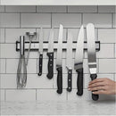 nzmegabuy silver magnetic knife strip mounted on a white tiled wall holding various kitchen knives and utensils
