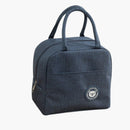 nzmegabuy navy blue insulated lunch bag with carry handles and a cute bear logo patch on a wooden kitchen table