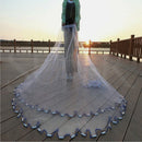 nzmegabuy durable nylon fishing cast net with steel sinkers being held on a wooden pier at sunset