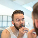 nzmegabuy silver rechargeable nose and ear hair trimmer being used by a man in front of a bathroom mirror