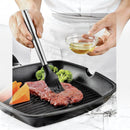 nzmegabuy black silicone basting brush with stainless steel handle brushing oil onto steak in a grill pan