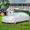 nzmegabuy 3-layer waterproof aluminum car cover with reflective strips, protecting a sedan parked on a lawn.